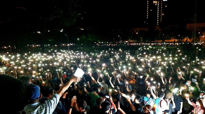 Students light their mobile phones during a protest against the government at Kasetsart University on February 29, 2020. Photo by Chonthicha Jangrew.